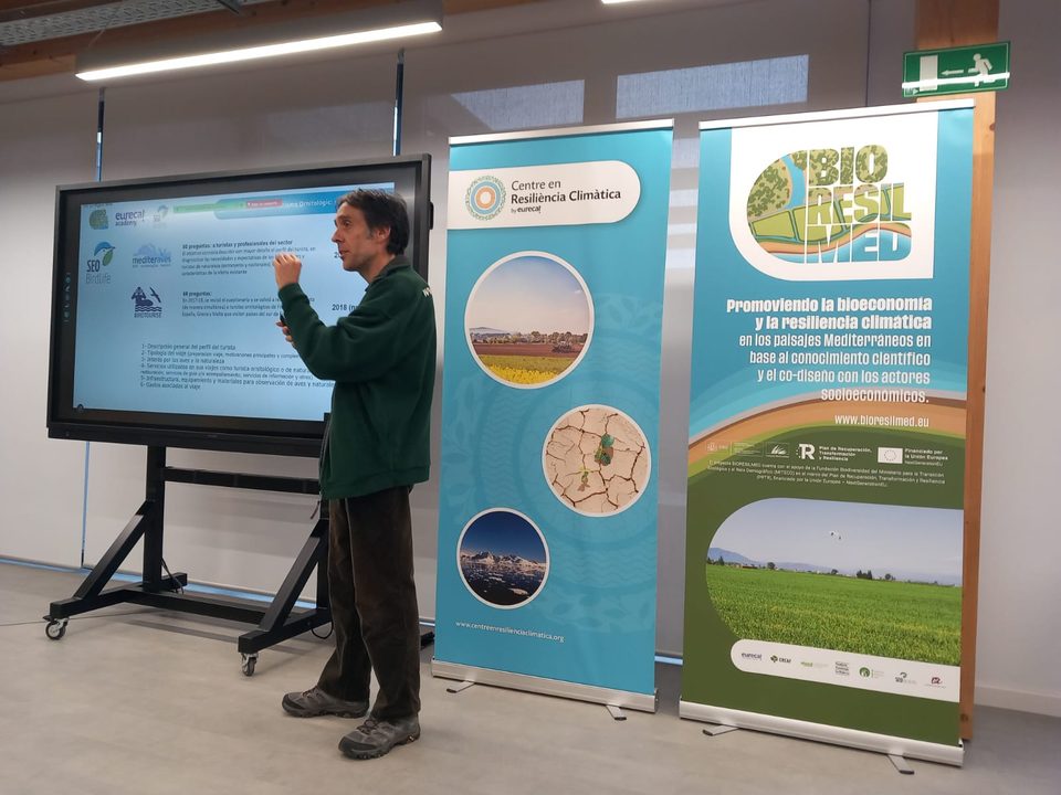 Presentación del proyecto BIORESILMED ante una pantalla y pancartas