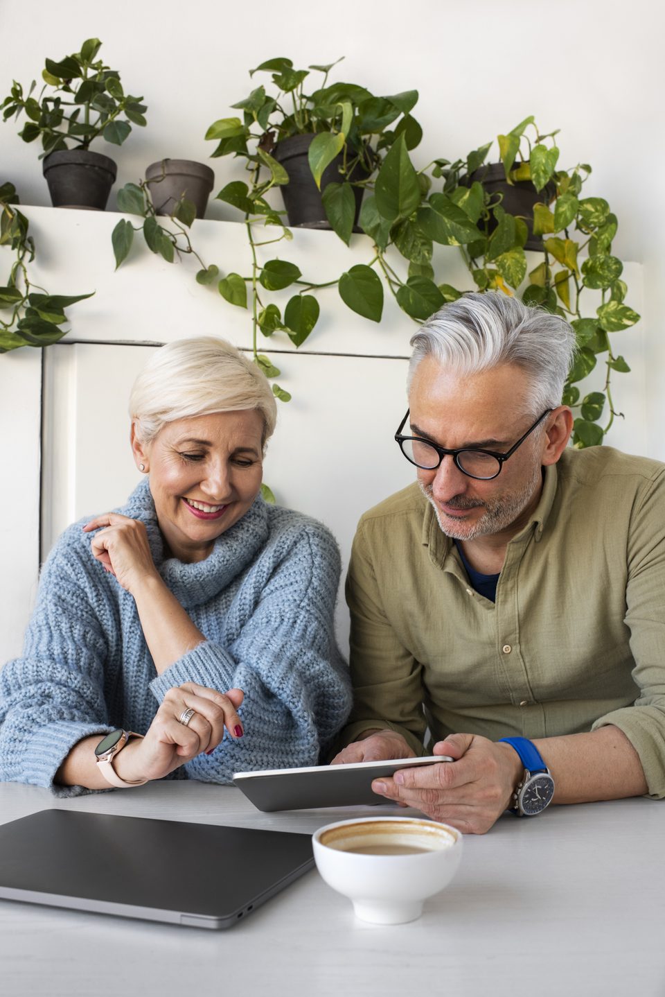 An older couple looking at a tablet together