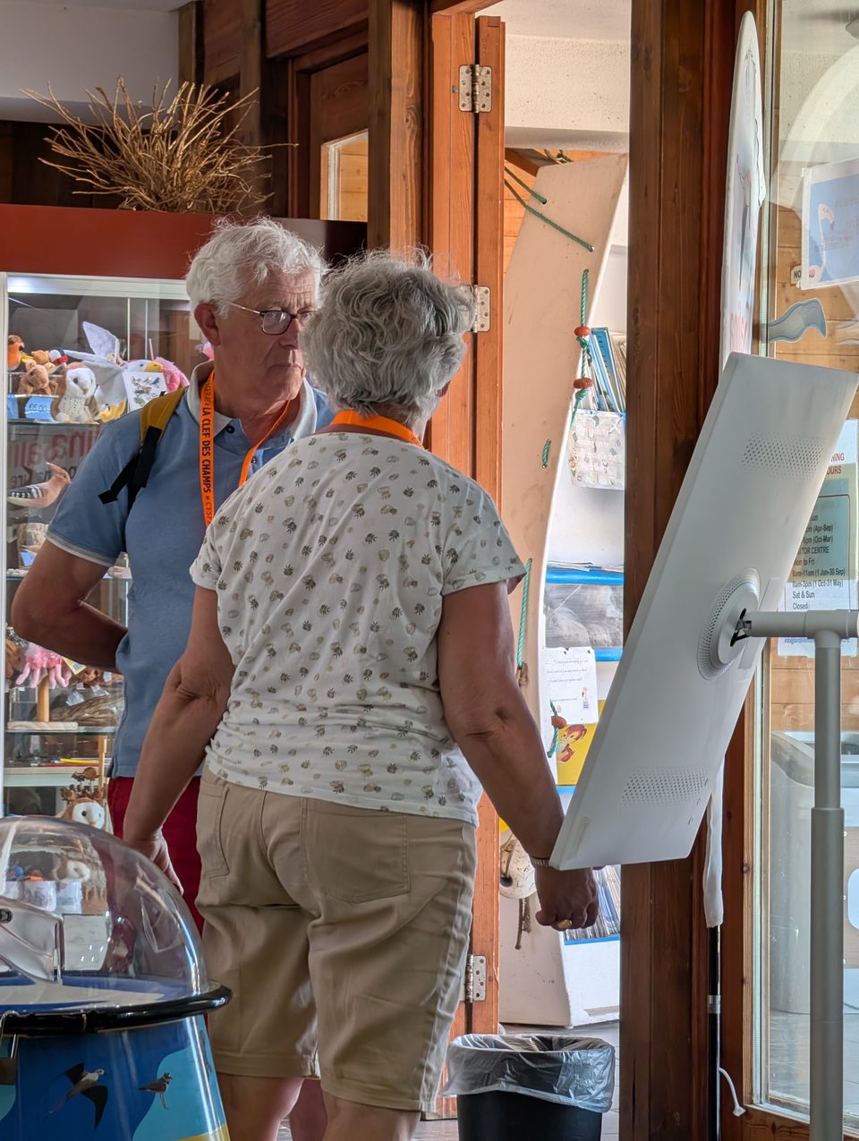 Visitors at an information screen in a nature reserve visitor centre