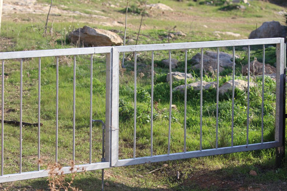 A new metal gate across a grassy track
