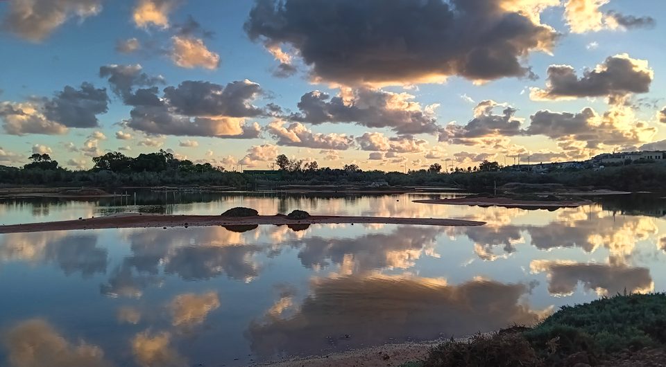 Dramatic clouds reflected in the full lake at Għadira Nature Reserve