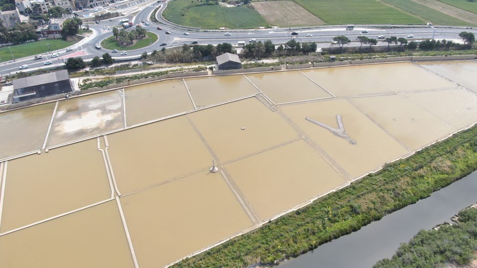 Aerial view of saltpans between roads and fields
