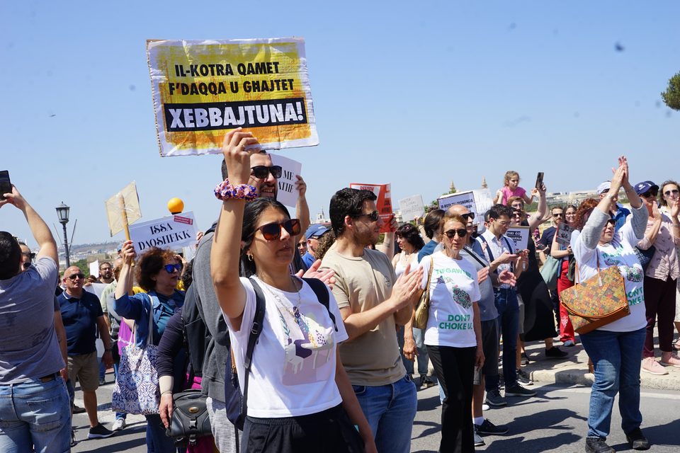 People at a street demonstration holding up protest signs