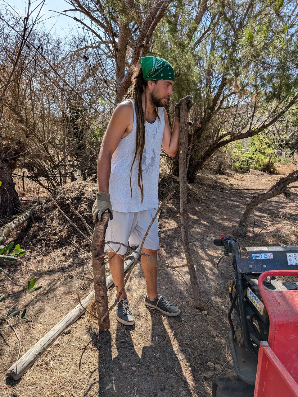 A volunteer with tools next to a generator in a wooded area