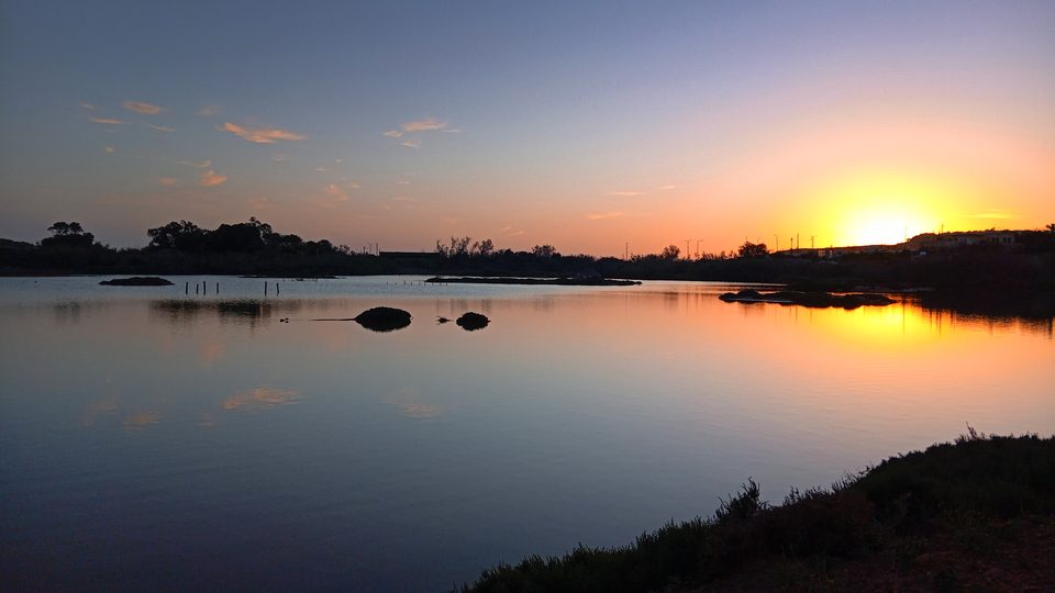 Sunrise over the still water of Għadira Nature Reserve, Malta